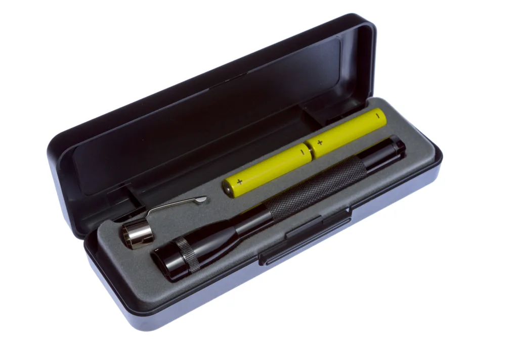 black flashlight in case with batteries