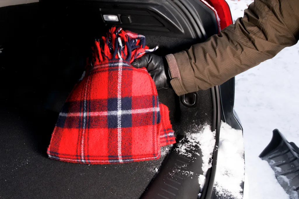 the driver placing a warm windproof blanket