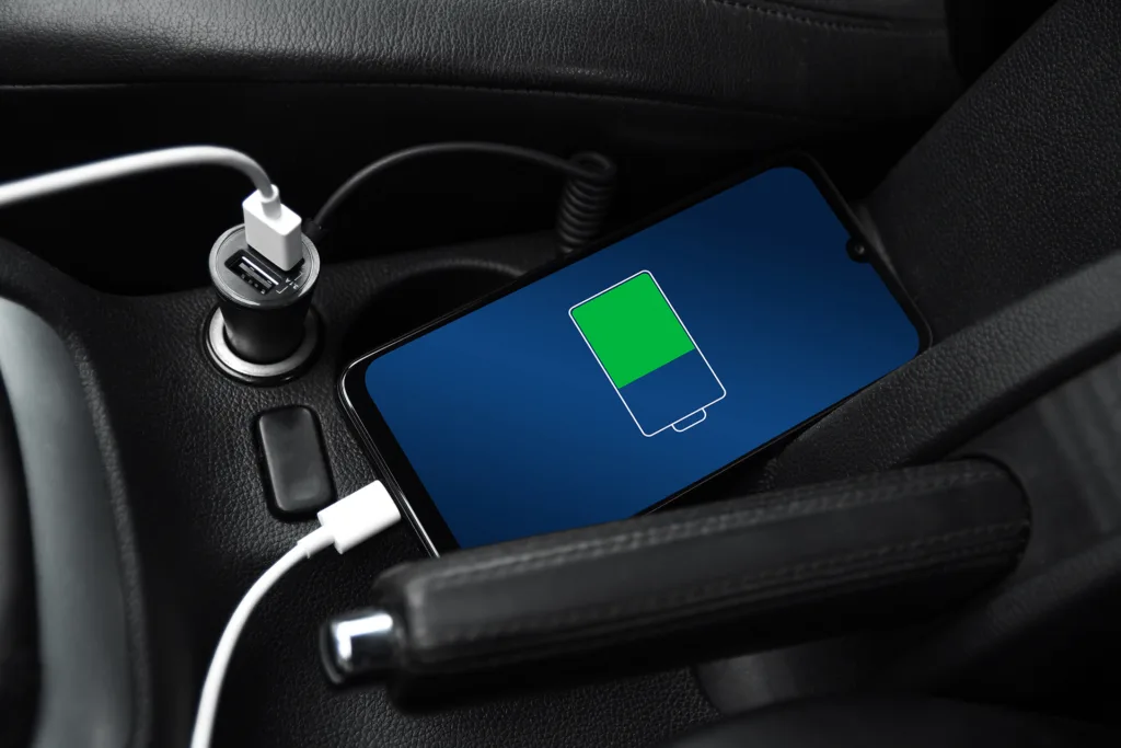Mobile phone smartphone charged with usb charger in the inside of car. 